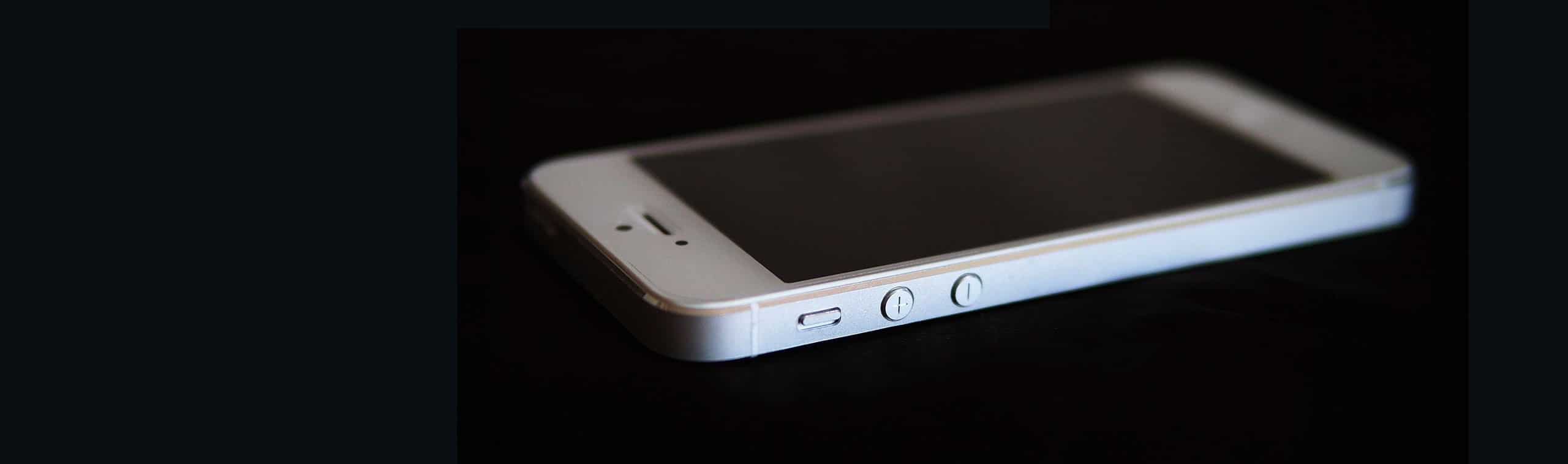 an iPhone 5 on a black background