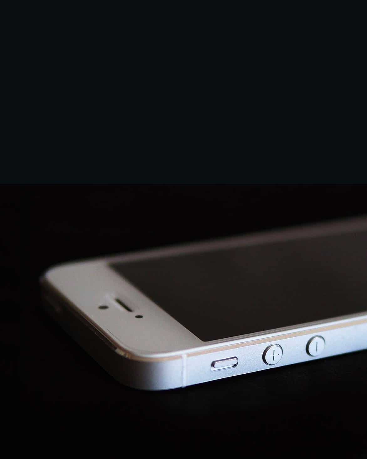 an iPhone 5 on a black background