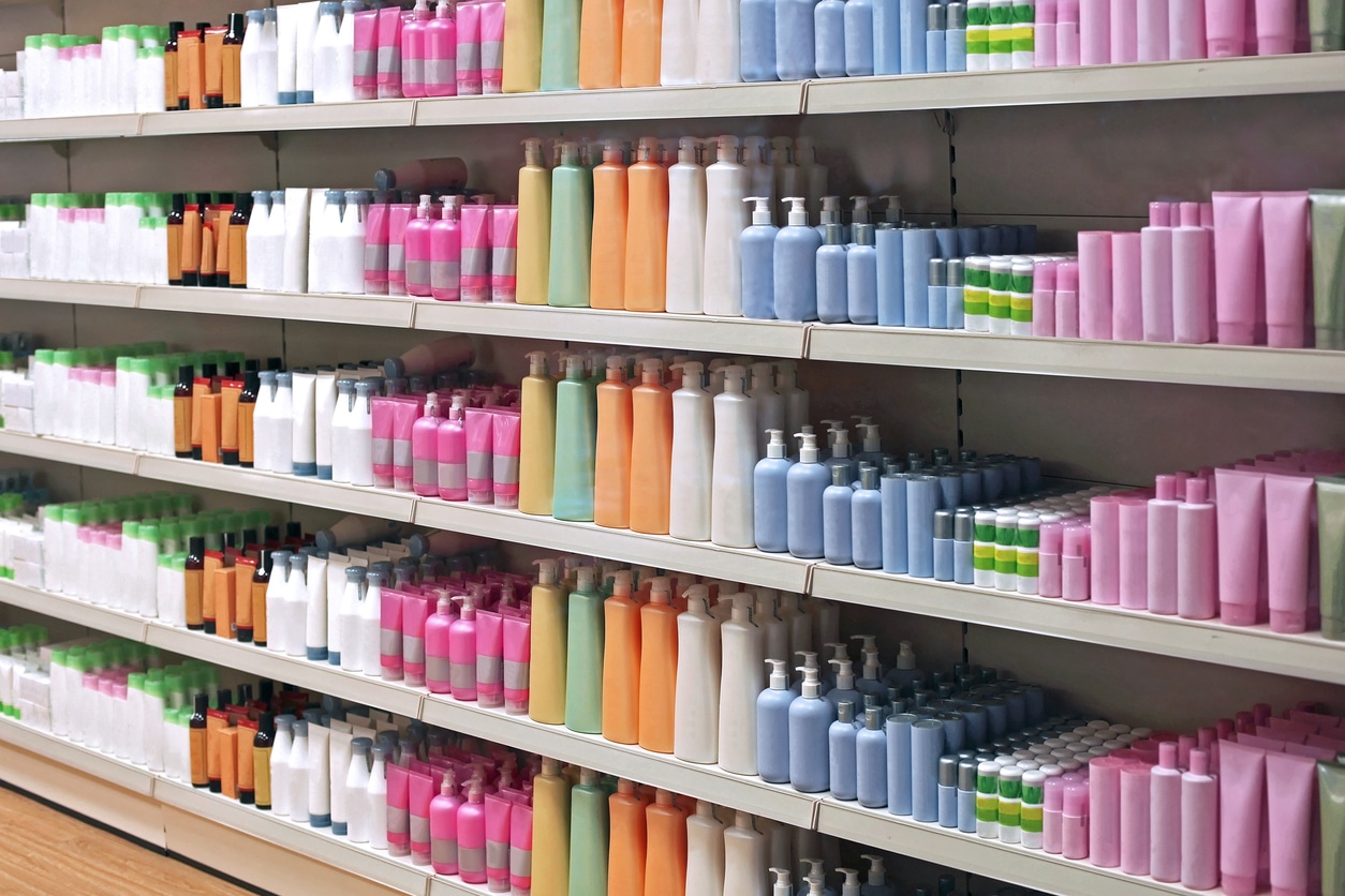 many bottles of shampoo on a supermarket shelf, presenting a difficult choice